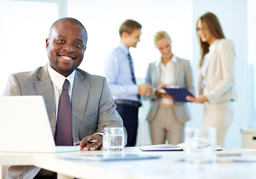 Portrait of a smiling businessman being at his workplace